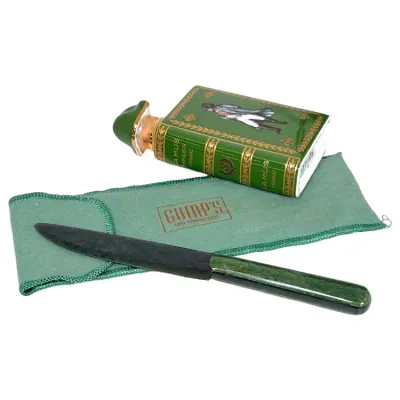 Sale Photo Thumbnail #160: Vintage Camus Napoléon Cognac book-form porcelain decanter alongside a Gump's San Francisco letter opener with a green stone handle and felt pouch.