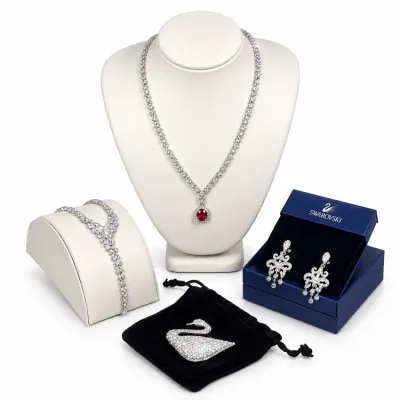 Sale Photo Thumbnail #10: Swarovski fine crystal jewelry collection, including a ruby pendant tennis necklace, chandelier earrings in an original box, a Y-necklace, and a pave swan brooch.