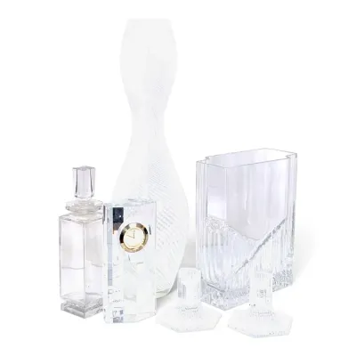 Sale Photo Thumbnail #231: Collection of clear crystal home decor including a decanter with stopper, small clock, tall frosted swirl vase, rectangular ice-like vase, and two candlesticks.