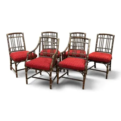 Sale Photo Thumbnail #140: Set of six tropical rattan dining chairs featuring two armchairs and four side chairs, all upholstered in textured red fabric.
