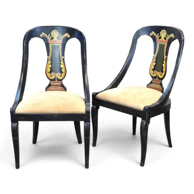 Sale Photo Thumbnail #139: Pair of Neoclassical style black-lacquered side chairs featuring hand-painted lyre splats and upholstered seats with light wear.