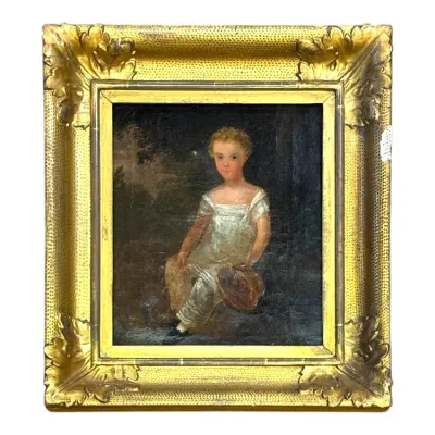 Sale Photo Thumbnail #80: Antique 19th-century folk art oil portrait painting depicting a child in a white gown, set in an ornate gilded frame with acanthus corner details.