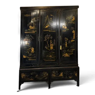 Sale Photo Thumbnail #128: Vintage Chinoiserie black lacquer wardrobe armoire with intricate gilt landscape and figure panels over lower drawers.