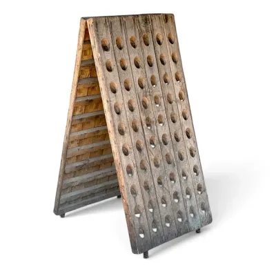 Sale Photo Thumbnail #242: Vintage French-style wooden Champagne riddle rack with an A-frame construction and weathered rustic finish.