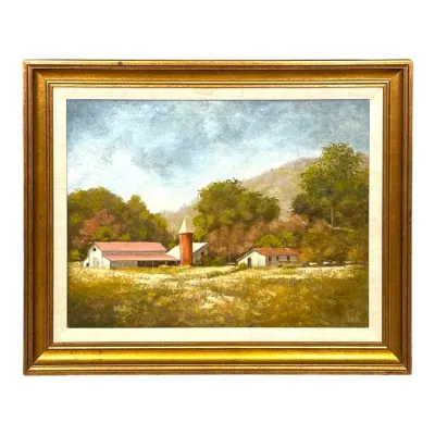 Sale Photo Thumbnail #105: Framed oil painting depicting a rural farm landscape with barns and a silo set against lush foliage and mountains. Signed in the lower right corner and presented in a molded gold-tone wooden frame with a cream liner.