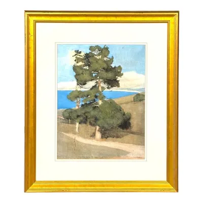 Sale Photo Thumbnail #33: Framed coastal landscape print depicting cypress trees along a dirt path overlooking the ocean, set in a gold gilt frame with a white mat.