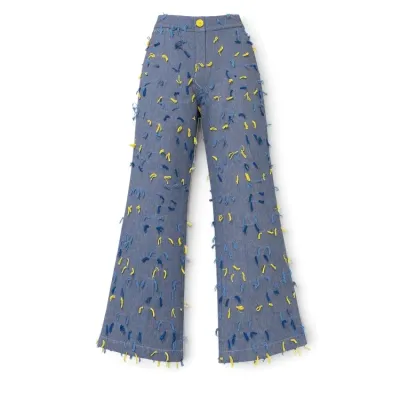 Sale Photo Thumbnail #17: Vintage-style blue denim flare pants adorned with colorful yellow and blue yarn fringe tufts throughout.