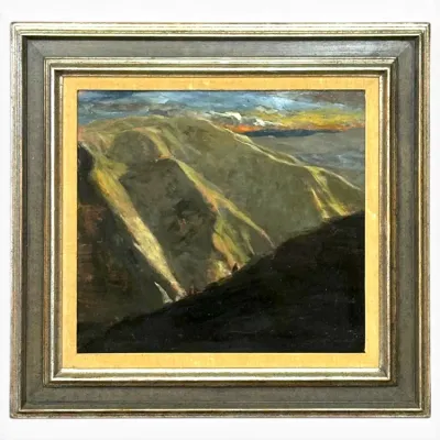 Sale Photo Thumbnail #115: Framed oil painting depicting a dramatic mountain landscape with dramatic light and shadows, housed in a tiered gilt and muted green wooden frame.