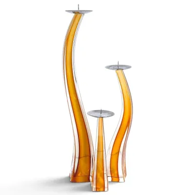 Sale Photo Thumbnail #236: Set of three modern amber casing art glass pillar candle holders featuring fluid, sweeping curved stems and polished metal wax bobeches.