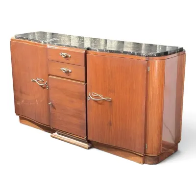 Sale Photo Thumbnail #131: Art Deco wood sideboard featuring a dark marble top, rounded corners, and ornate ribbon-style brass handles.