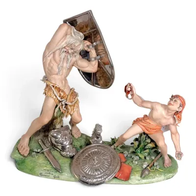 Sale Photo Thumbnail #219: Capodimonte porcelain sculpture titled 'Davide e Golia' by Luciano Cazzola, depicting the battle between David and Goliath with silvered metallic accents.