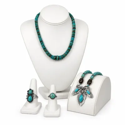 Sale Photo Thumbnail #8: Southwestern-style turquoise and sterling silver jewelry collection, including two bead necklaces, a leaf-pendant necklace, and two statement rings.