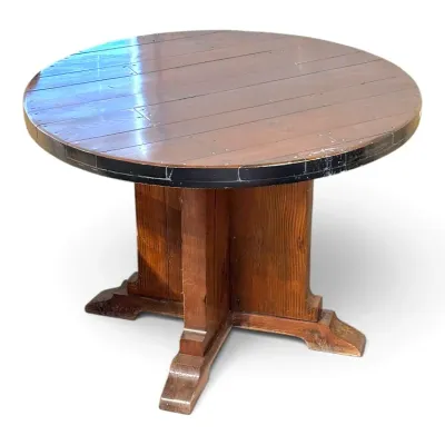 Sale Photo Thumbnail #125: Round rustic wooden pedestal dining table with plank top construction and a dark trim border.