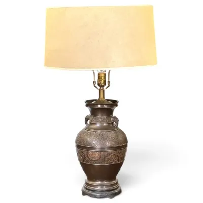 Sale Photo Thumbnail #187: Vintage Asian-style bronze table lamp with intricate embossed relief patterns, side handles, and a large drum shade.