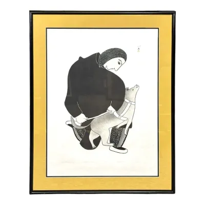 Sale Photo Thumbnail #91: Framed Inuit art print depicting a figure in a parka with a dog, set in a yellow mat and sleek black frame.