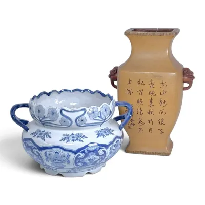 Sale Photo Thumbnail #225: Blue and white hand-painted ceramic bowl with double handles alongside an Asian beige pottery vase featuring calligraphic inscriptions and animal-head handles.