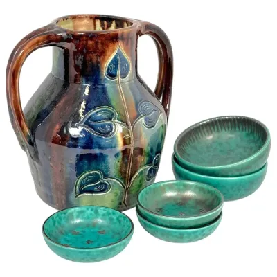 Sale Photo Thumbnail #161: Handcrafted art pottery set featuring a double-handled vase with incised leaf motif and five matching turquoise-glazed small bowls.