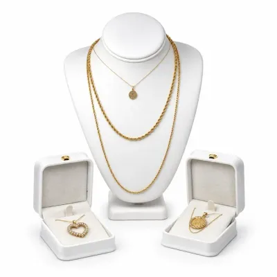 Sale Photo Thumbnail #4: Collection of Vintage 14k and 18K jewelry including rope chains, a coin pendant necklace, and a rhinestone heart pendant displayed on a white bust and in boxes.