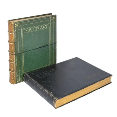 Sale Photo Thumbnail #167: Two antique leather-bound books, including a green copy of 'The Stuarts' with gilt tooling and a black volume titled 'Our Michigan Friends - As We See 'Em.'