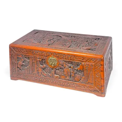Sale Photo Thumbnail #207: Hand-carved camphor wood chest with intricate relief scenes of figures and landscapes, featuring a brass latch hardware, likely 20th-century Chinese origin.