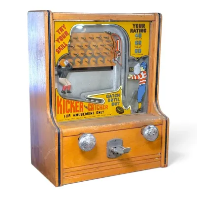 Sale Photo Thumbnail #171: Vintage J.F. Frantz Kicker and Catcher 1-cent countertop arcade machine in a wooden cabinet.
