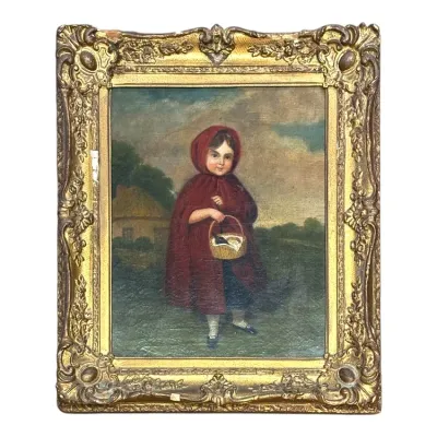 Sale Photo Thumbnail #81: 19th-century folk art oil painting depicting Little Red Riding Hood in a hooded red cloak, housed in an ornate gilt gesso frame with visible surface wear and small chips.