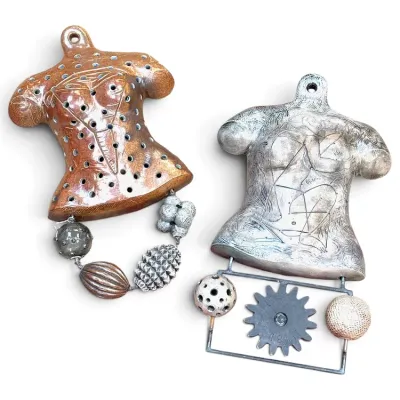 Sale Photo Thumbnail #234: Pair of contemporary artisan ceramic wall hanging sculptures featuring female torso forms with mixed-media dangling accents.