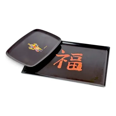 Sale Photo Thumbnail #211: Pair of Japanese black lacquer trays, featuring one smaller tray with a samurai motif and a larger tray with red foil calligraphy.