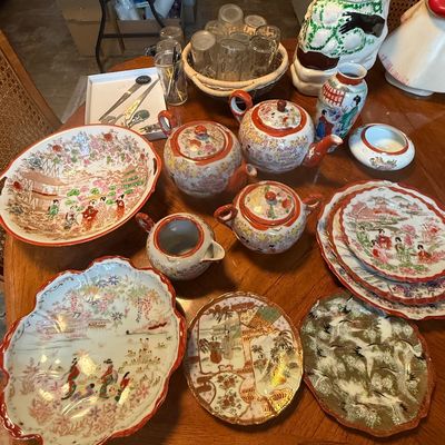 Sale Photo Thumbnail #89: Collection of Japanese Kutani and eggshell porcelain tableware, including teapots, serving bowls, plates, and a sugar bowl, shown alongside glassware and ceramic cookie jars.