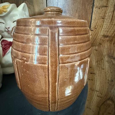 Sale Photo Thumbnail #35: Vintage brown glazed stoneware cookie jar with a barrel-style design and matching lid.