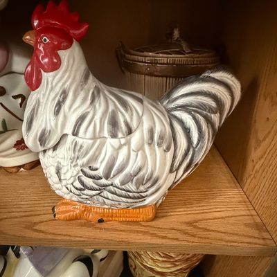 Sale Photo Thumbnail #26: Vintage ceramic rooster cookie jar, featuring hand-painted black, white, and red details, sitting on a shelf.