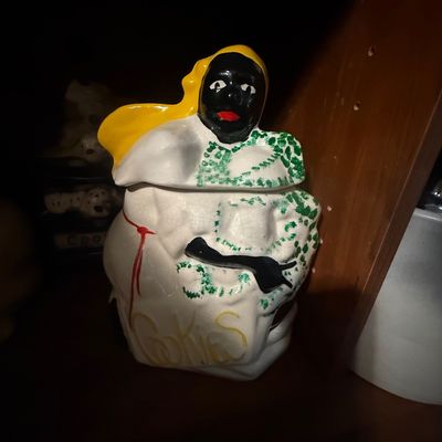 Sale Photo Thumbnail #19: Vintage ceramic Black Americana mammy cookie jar featuring hand-painted details and crazing on the white glaze.