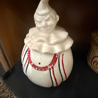 Sale Photo Thumbnail #27: Vintage ceramic clown cookie jar featuring a white glazed body with red and black painted stripes, showing some paint wear on details.