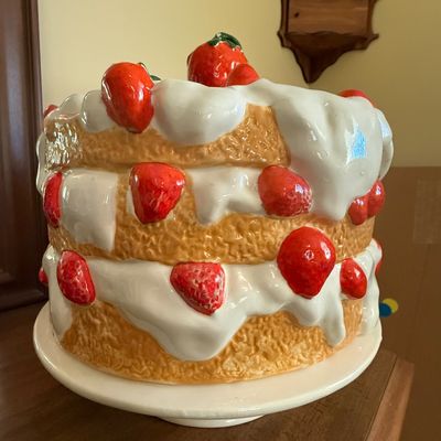 Sale Photo Thumbnail #42: Vintage ceramic strawberry shortcake-style cookie jar sitting on an integrated pedestal base.