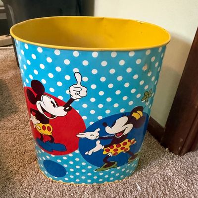 Sale Photo Thumbnail #57: Vintage Mickey and Minnie Mouse tin wastebasket with a light blue polka dot pattern and yellow interior, showing light wear.