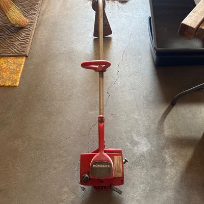 Sale Photo Thumbnail #74: Vintage red Homelite gas-powered string trimmer weed eater showing moderate age and wear.