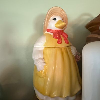 Sale Photo Thumbnail #6: Vintage ceramic duck cookie jar dressed in a yellow apron, bonnet, and red bow, late 20th century.