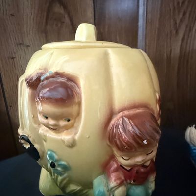 Sale Photo Thumbnail #31: Vintage mid-century ceramic cookie jar depicting Peter Peter Pumpkin Eater, featuring hand-painted details and a glazed finish.