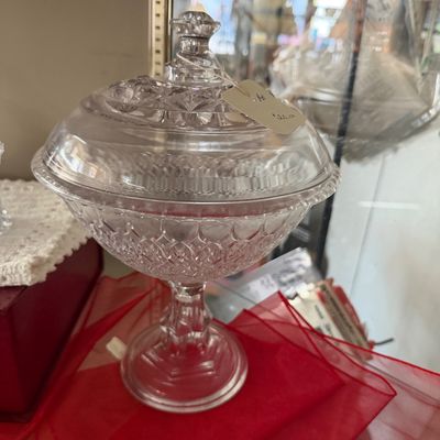 Vintage pressed clear glass covered candy dish on a pedestal base with a diamond pattern design.