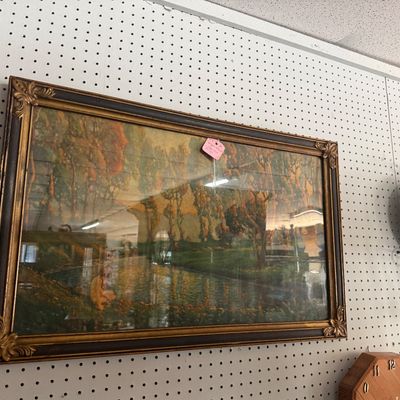 Framed vintage Maxfield Parrish print titled "Daybreak," housed in a dark wooden frame with ornate gilded corners, displayed...