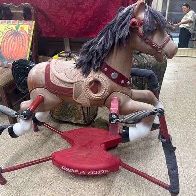 Vintage Radio Flyer spring-mounted rocking horse with synthetic mane and molded plastic saddle details.