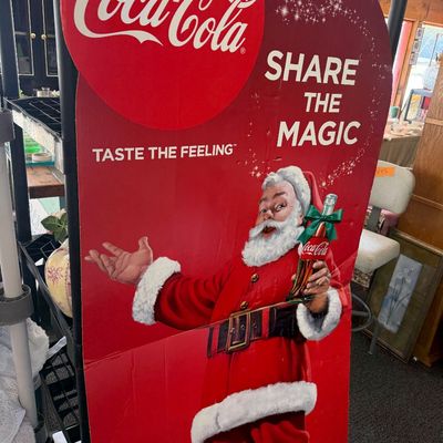 Vintage Coca-Cola Christmas cardboard standee display featuring Santa Claus, reading "Share the Magic" and "Taste the...