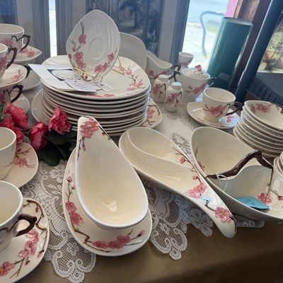 Franciscan Desert Rose pattern ceramic dinnerware set, including teacups, saucers, serving bowls, and plates.