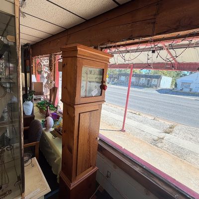 Vintage solid pine tall case grandfather clock featuring a glass-front dial door and a lower wooden door.