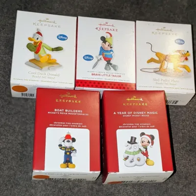 Sale Photo Thumbnail #37: Collection of five Hallmark Keepsake Disney Christmas tree ornaments in their original boxes, including Mickey Mouse, Donald Duck, and Pluto.