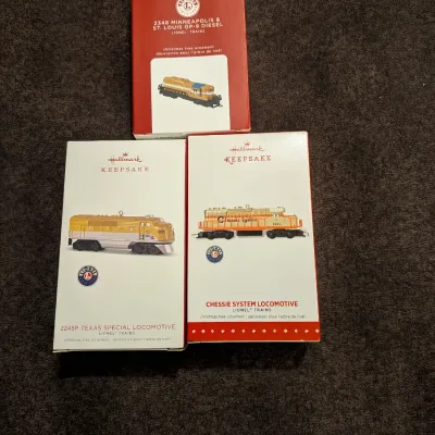 Sale Photo Thumbnail #44: Set of three boxed Hallmark Keepsake Lionel Trains Christmas tree ornaments, including Minneapolis & St. Louis GP-9 Diesel, 2245P Texas Special Locomotive, and Chessie System Locomotive.