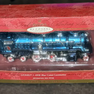 Sale Photo Thumbnail #58: Hallmark Keepsake Ornament featuring the Lionel 1-400E Blue Comet Locomotive, complete in its original decorative box.