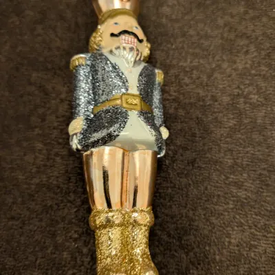 Sale Photo Thumbnail #78: Blown glass nutcracker Christmas ornament featuring glitter accents on the jacket and boots.