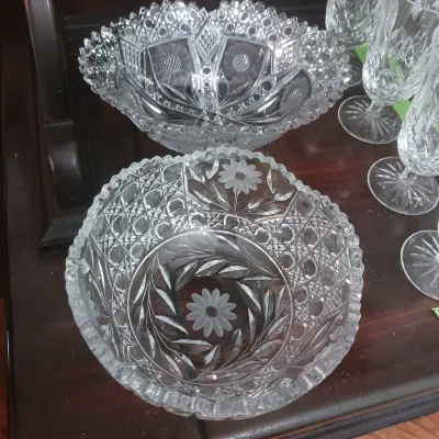Sale Photo Thumbnail #25: Two vintage American Brilliant Cut Glass bowls featuring floral etchings and diamond geometric patterns, displayed alongside crystal stemware.