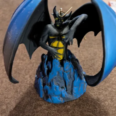 Sale Photo Thumbnail #45: Disney's Fantasia Chernabog ornament depicting the villainous demon figure with large blue wings, emerging from a rocky mountain base.